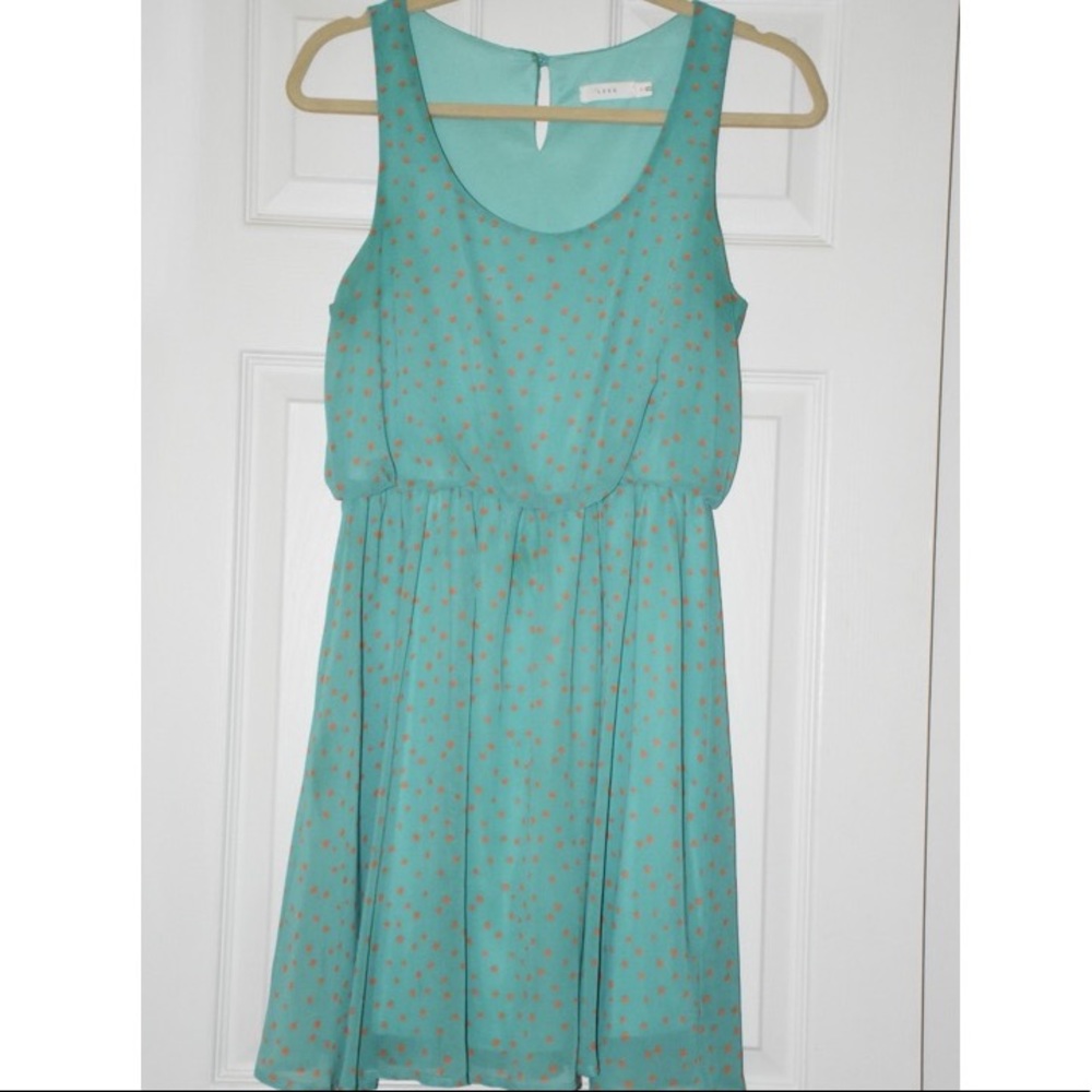 Green dress with orange polka-dots
